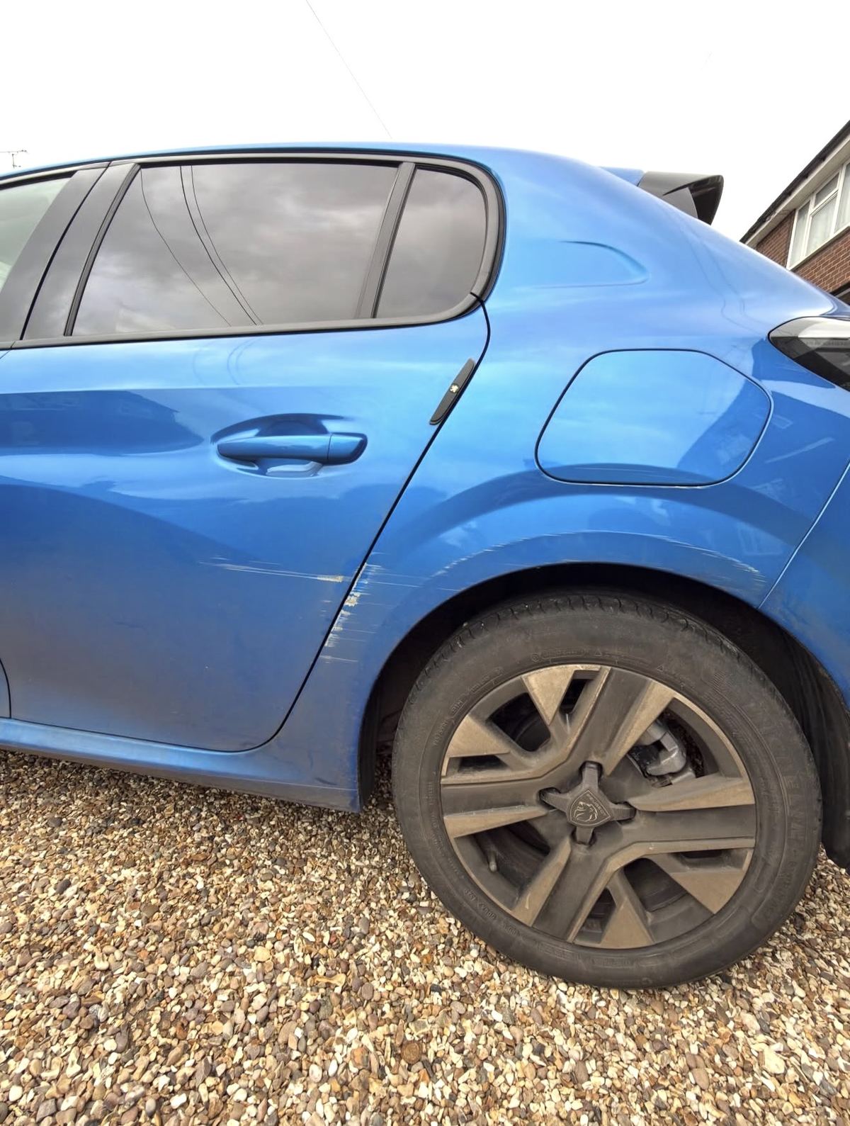 Peugeot door scratch and scuff before repair — Technicolour Smart Repair Surrey