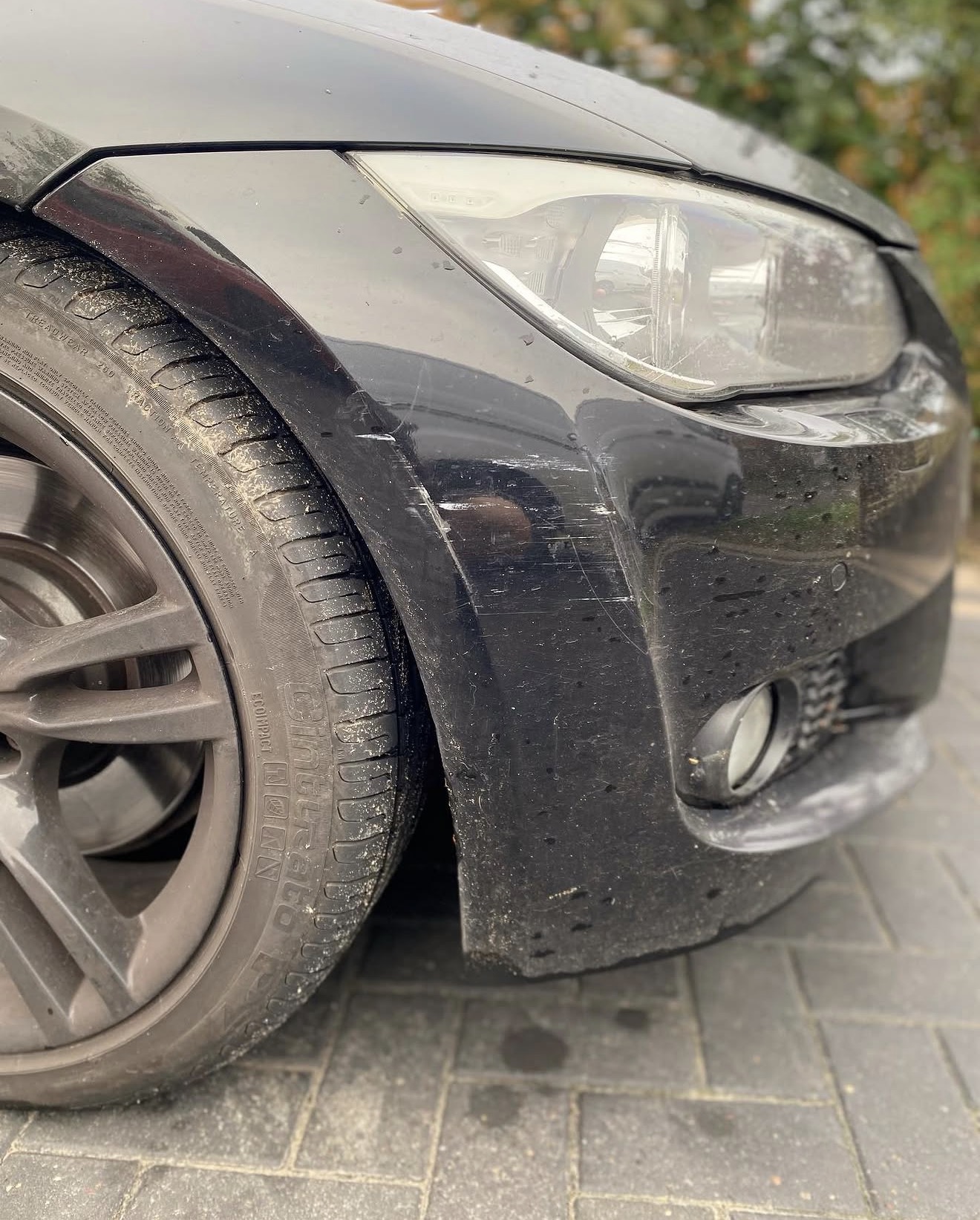 BMW black front bumper before repair - scuff and scrape damage, Camberley
